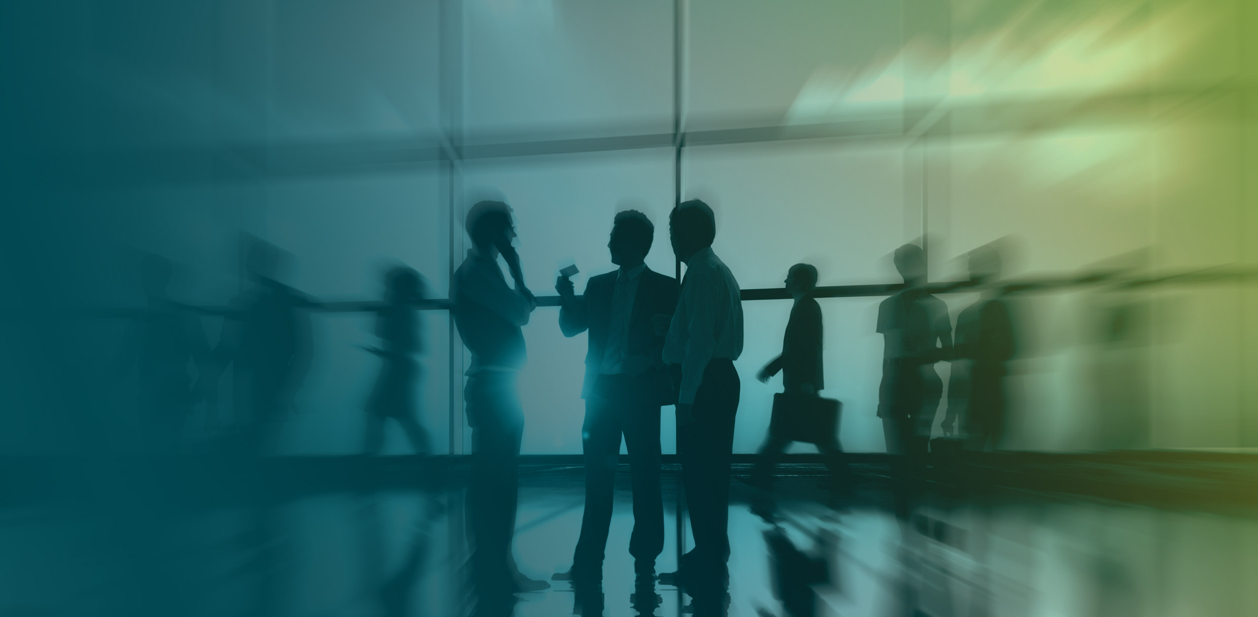 Silhouettes of people engaging in conversation in a modern interior space with a blurred background, suggesting movement and dynamic interaction.