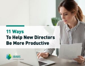 Person in striped shirt works at a desk, reading a document. Text on image: "11 Ways To Help New Directors Be More Productive."