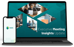 Conference room setting with diverse persons discussing business. Laptop displays "Executive Meeting Insights Update." A smartphone shows the IBABS logo.