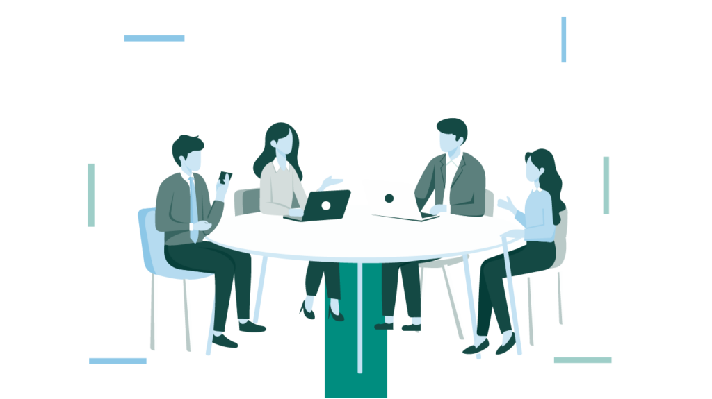 Four people in business attire sit around a round table, discussing, with laptops and a phone in a minimalist background.